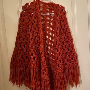 Burnt orange hand knit shawl.